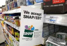 Shelf sign in a grocery aisle showing SNAP EBT acceptance
