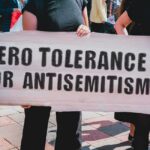 Protester holding a large sign at a rally