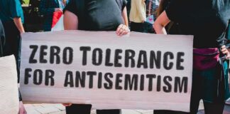 Protester holding a large sign at a rally
