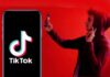 Perez Hilton TikTok Live Triggers Police Rush Smartphone displaying TikTok logo with person taking selfie in red light