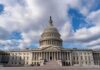 United States Capitol building under a partly cloudy sky