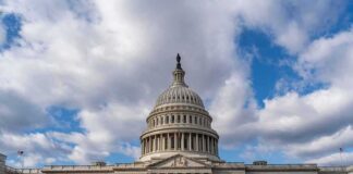 United States Capitol building under a partly cloudy sky