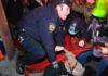 Police officer restraining a protester on the ground during a crowd encounter