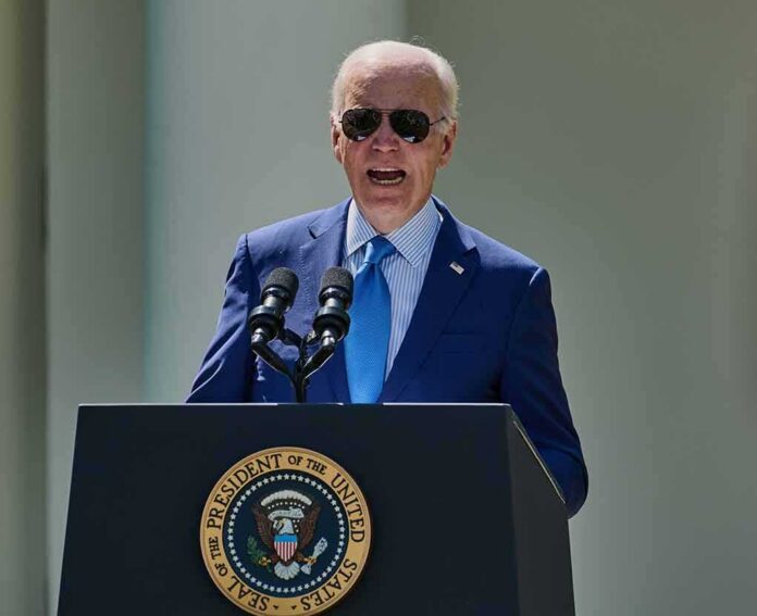 man in blue suit speaking at a podium with presidential seal