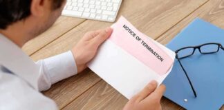 person opening envelope at desk