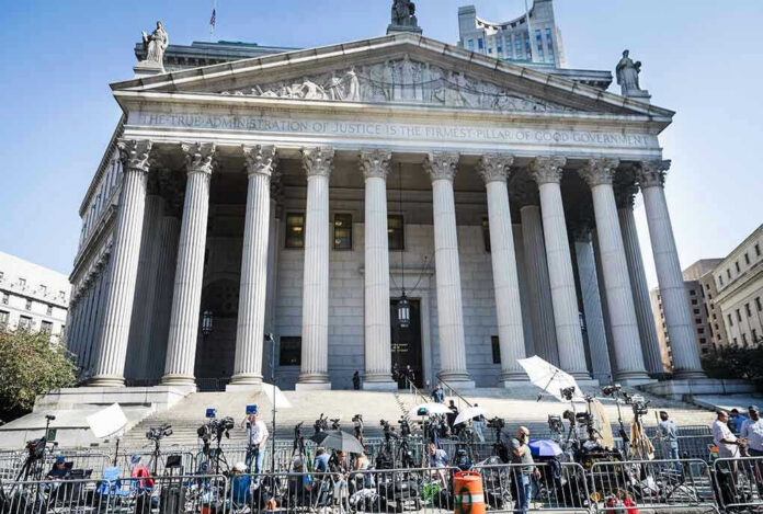 2445868619-1 Teddy Williams at courthouse steps with media outside a neoclassical building