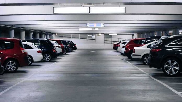 shutterstock_1014849688-1 Row of parked cars in an indoor parking garage