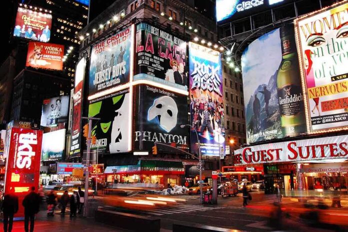 shutterstock_1029004501 Vibrant night scene of Times Square filled with theater advertisements and neon lights