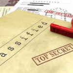 Pentagon Expands Leak Probe With Polygraph Tests Classified documents with red Top Secret stamp and rubber stamp