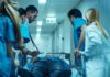 Left at ER, Freshman Dies After Frat Night Medical team rushing patient on a gurney through hospital corridor
