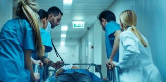 Medical team rushing patient on a gurney through hospital corridor