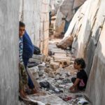 Children Trapped In Haiti’s War children in a narrow alley with rubble