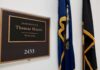 House Delays Hegseth Impeachment Vote office door plaque with name and room number beside flags