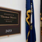 House Delays Hegseth Impeachment Vote office door plaque with name and room number beside flags