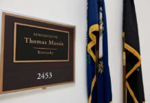 House Delays Hegseth Impeachment Vote office door plaque with name and room number beside flags