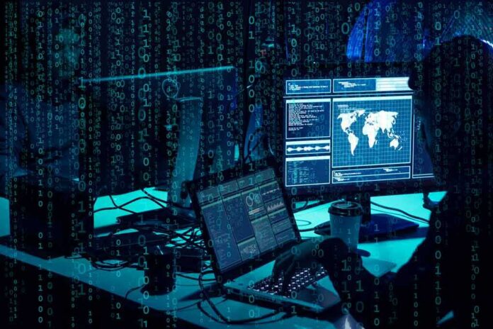 shutterstock_1399823822-1 cybersecurity analysts at workstations with code and world map on screens