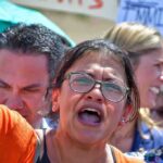 Rashida Tlaib speaking at a rally with Pete Aguilar and Ayanna Pressley in the crowd