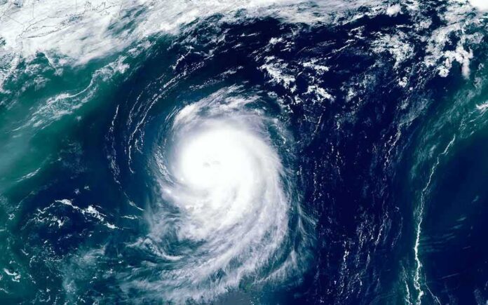 shutterstock_1493291597 Satellite view of a powerful hurricane swirling over the ocean
