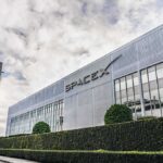 SpaceX headquarters exterior with rocket booster and hedge