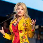 A Legend’s Final Goodbye Dolly Parton performing on stage in a yellow floral jacket