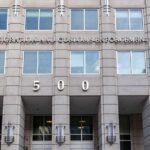 British Commentator Detained by ICE in Louisiana US government building facade with flags and number 500