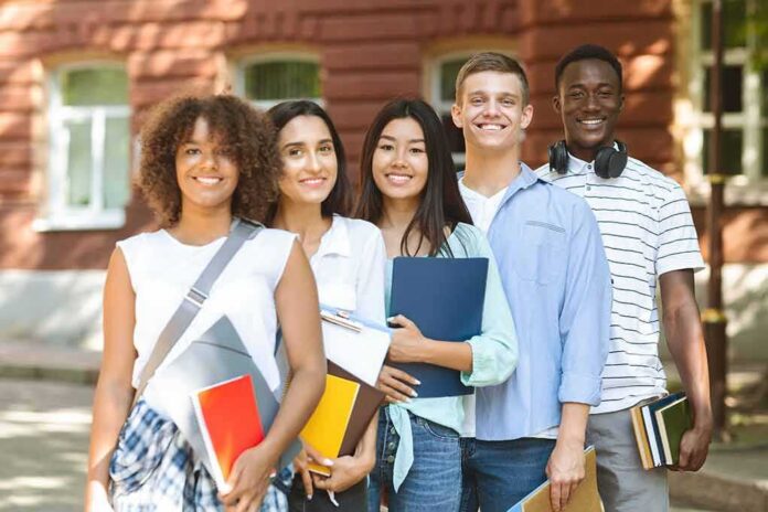 shutterstock_1757465525 Group of students standing outdoors with notebooks