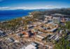 Aerial view of lakeside city with casinos, hotels, and pine forests