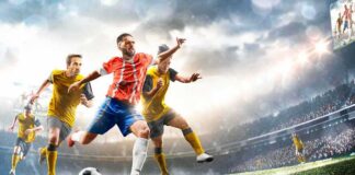 Soccer player in red jersey kicking ball during match