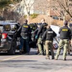 Familicide Horror Shakes “Safe” City Police and sheriff officers gather around vehicles on a suburban street