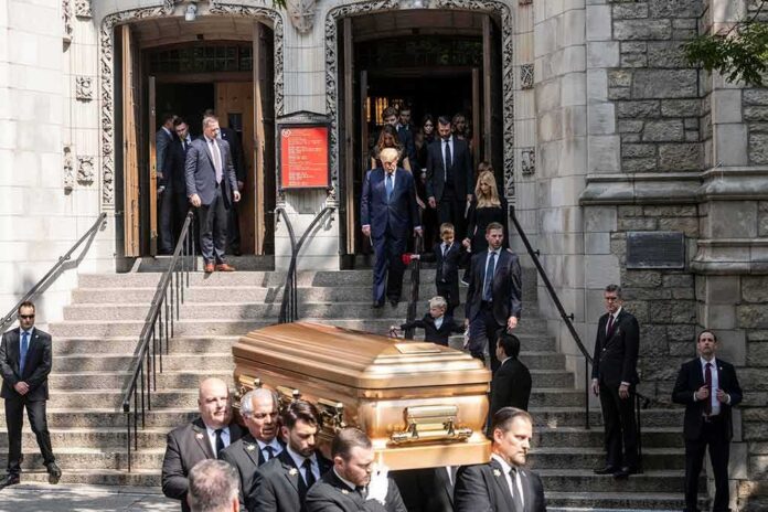 Pallbearers carry a casket down church steps