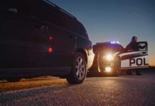 California Toughens Repeat DUI Laws Police officer at patrol car during traffic stop at dusk