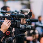 Trump Officials Push Ukraine-Russia Peace Deal Video cameras on tripods at a media event