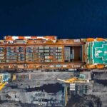 Cargo ship docked at port seen from above