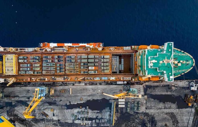 Cargo ship docked at port seen from above