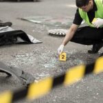 Minneapolis Gunman Faced Documented Threats Forensic investigator marking evidence at crash scene