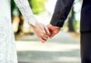 Bride and groom holding hands outdoors