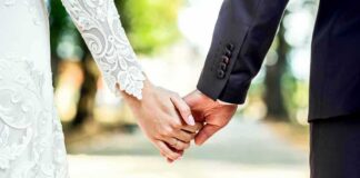 Bride and groom holding hands outdoors