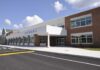 Modern school building with large windows and a clear sky
