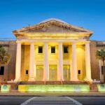 Supreme Court building with illuminated columns at dusk