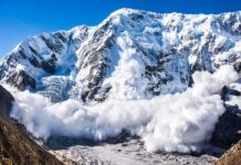 American Climber Found Dead After Deadly Avalanche Snow avalanche sweeping down a rugged mountain
