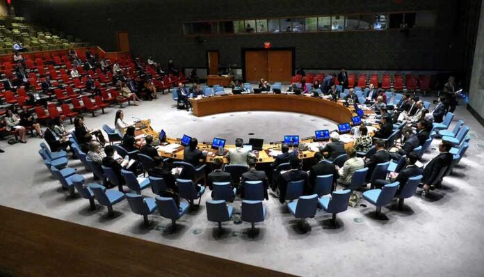 Conference delegates seated in a circular meeting room