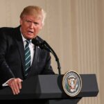 The Correspondents’ Dinner Became a Trump Show Donald Trump speaking at a podium with presidential seal