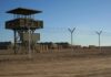 U.S. Base Plan Advances in Poland Guard tower beside barbed-wire fence in desert camp