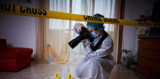 forensic photographer documenting indoor crime scene