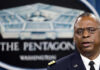 Lloyd Austin speaking at a podium in front of a Pentagon emblem