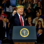 Trillion-Dollar Questions Surround Trump’s $5,000 Plan Donald Trump speaking at a rally behind a presidential podium