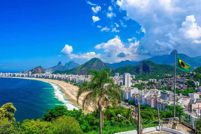 shutterstock_1369316819-1 Copacabana Beach coastline with city skyline and mountains