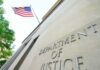 Hundreds of Trees Trigger Federal Showdown Department of Justice building with American flag