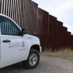 Judge Blocks Border Work in Big Bend Border patrol SUV parked beside tall steel border fence
