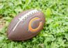 Football on grass with orange C logo